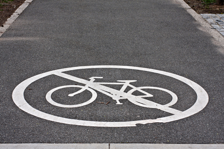 white painted sign for no bike line on asphalt pavementの写真素材