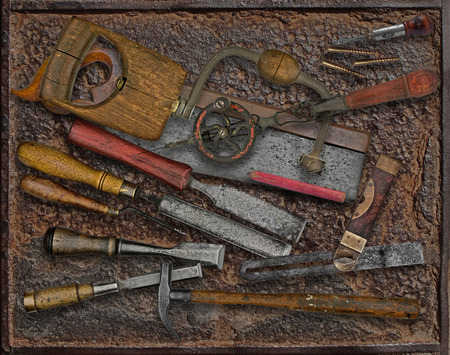 vintage woodworking tools over rusty industrial metal plateの写真素材
