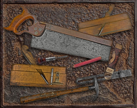 vintage woodworking tools over rusty industrial metal plateの写真素材