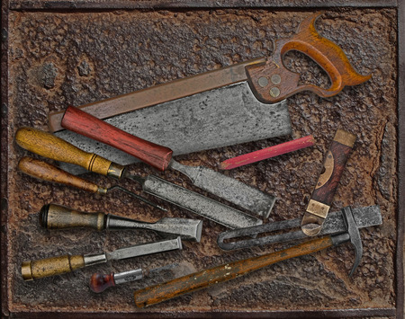 vintage woodworking tools over rusty industrial metal plate