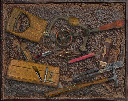 vintage woodworking tools over rusty industrial metal plateの写真素材