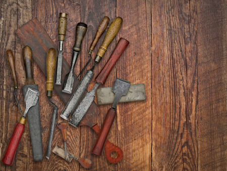 set of vintage chisels and sharpening stones, strop over wooden bench, space for your text