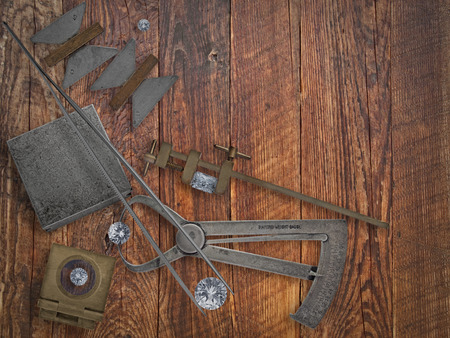 vintage jeweler tools and diamonds over wooden bench, space for textの写真素材