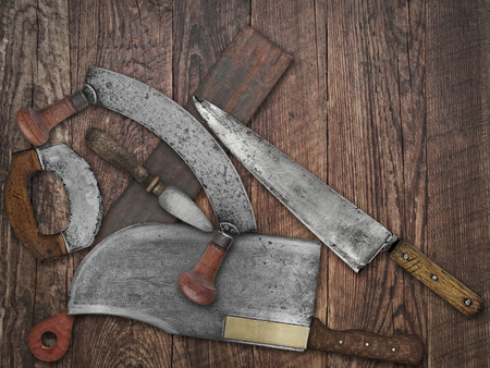 faded colors if a vintage kitchen knives and sharpening tools collage over old wooden table, space for your textの写真素材