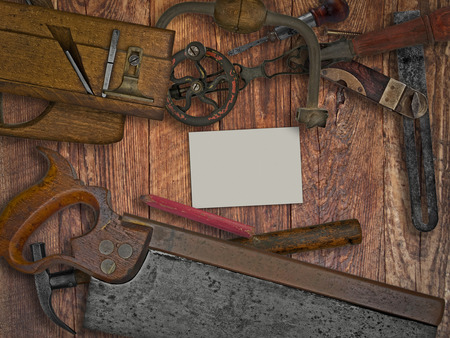 vintage woodworking tools on wooden bench, space for your text on a blank business cardの写真素材