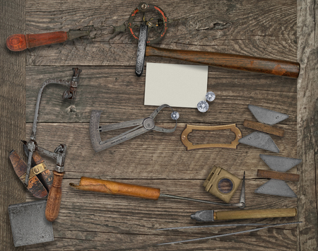 vintage jeweler tools and diamonds over wooden bench, blank card for your businessの写真素材