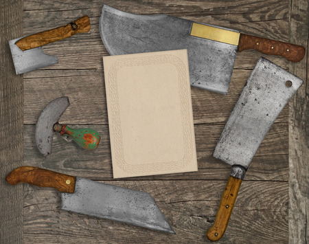 vintage kitchen knives and utensils over wooden  board, blank card for your textの写真素材