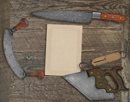 vintage kitchen knives and utensils over wooden board board, blank card for your textの写真素材