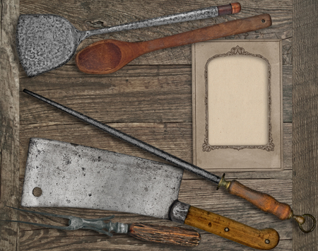 vintage kitchen utensils over wooden board, blank card for your textの写真素材