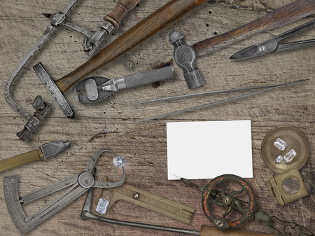 vintage jeweler tools and diamonds over wooden bench, space for your business nameの写真素材