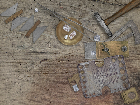 vintage jeweler tools and diamonds over wooden bench, space for your business nameの写真素材