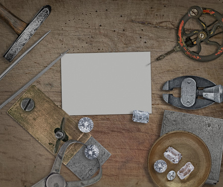 vintage jeweler tools and diamonds over wooden bench, blank card for your businessの写真素材