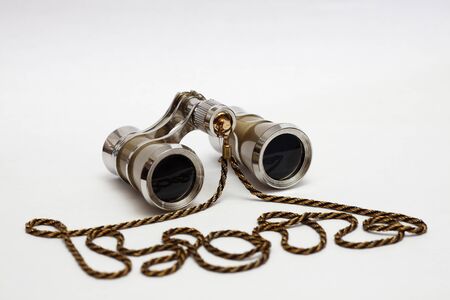 opera glasses with a strap on a white backgroundの写真素材