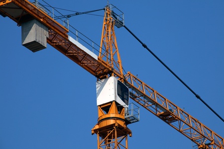 close-up of a tower crane cab on blue sky backgroundの写真素材