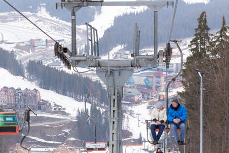 Bukovel, Ukraine - March 15, 2018: Ski lift. People climb to the top of the mountain. Ski resort in the Ukrainian Carpathians.のeditorial素材
