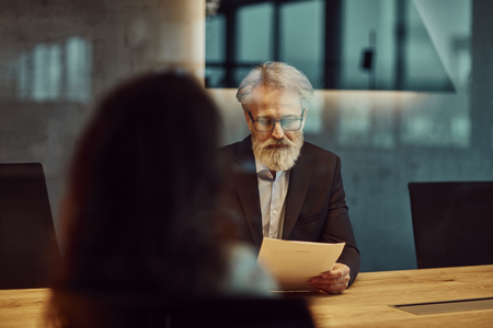 handsome caucasian senior CEO at a meeting.の写真素材