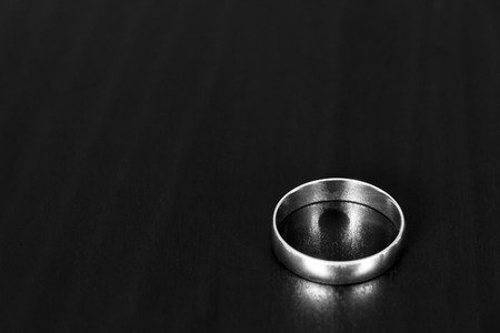 A wedding ring is a black table close upの写真素材