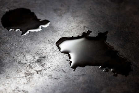Water is poured on a black kitchen counter