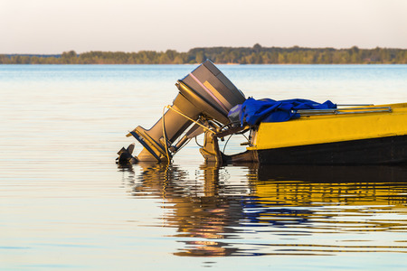 Part of a small motorboat is waiting at the shoreの写真素材