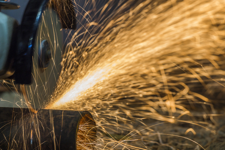 Sparks from cutting metal cutting tool manually.の写真素材