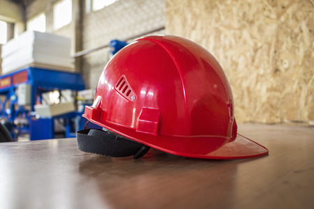 Production Red hard hat lying on the table during a break.の写真素材