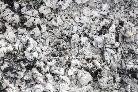 Burned coals closeup of a gray background.
