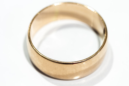 A wedding ring is a white table close up.の写真素材