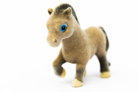 Figurine brown pony close-up on a white background.の写真素材