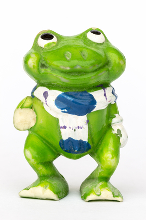 Statuette of a green frog close-up on a white background.の写真素材
