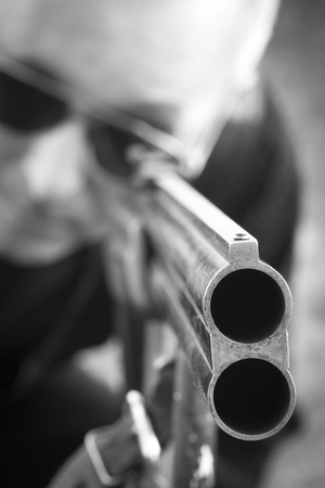 Man takes aim with a hunting rifle closeup.の写真素材