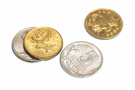 A few small coins close up on white background.