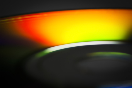 The surface of the CD close-up reflects the spectral colors.の写真素材