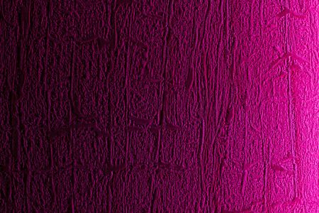 Wall close-up, side-lit LED light purple as background.の写真素材