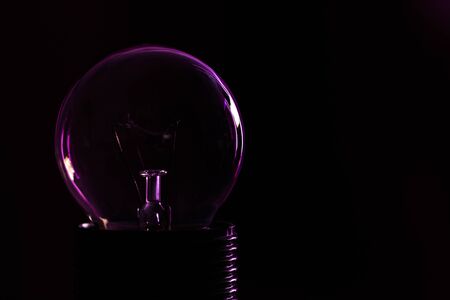 Light bulb close-up on a black background.の写真素材