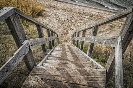 Old wooden staircase going to the river bank.