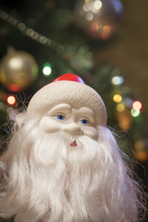 Santa Claus figurine close-up on the background of the Christmas tree.の写真素材