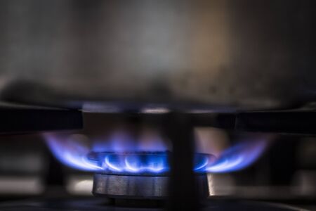 Burner gas stove close-up. Gas burns with a blue flame.の写真素材