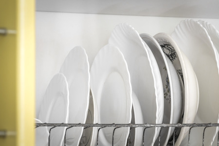 Clean dishes are in the kitchen cupboard.