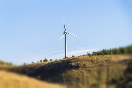 Small wind generators on a hill in the countryside.