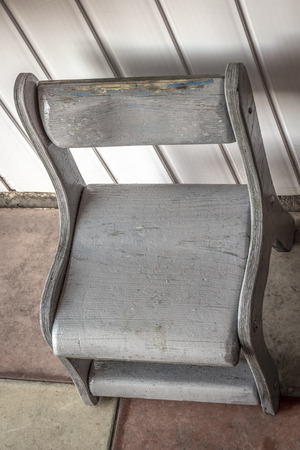 A small children's wooden chair in the corridor.の写真素材