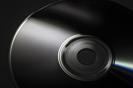 Reflection of the surface of a CD with artistic lighting close-up.の写真素材