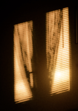 The projection of light from the window on the wall of the room.