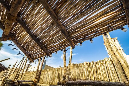 Canopy and reed fence in a rural area.