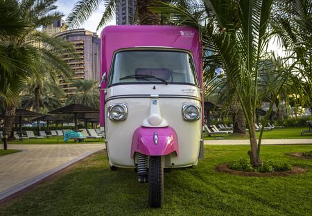 Dubai, UAE - December 2, 2018: Old cargo scooter at the Le Royal Meridien Beach Resort & Spa from the beach. Dubai Marina district.のeditorial素材