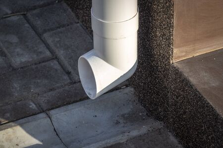 White drainpipe on the wall of a private house.の写真素材