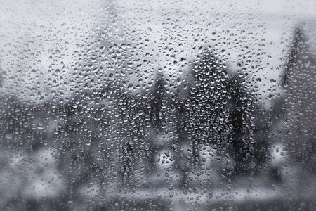 Water drops on the glass on a rainy day.
