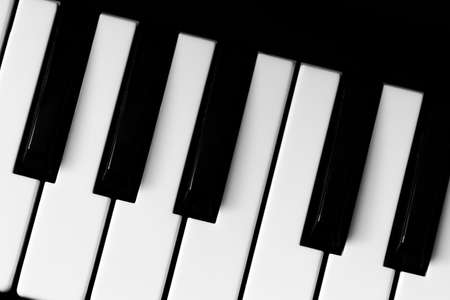 Black and white piano keys close up.の写真素材