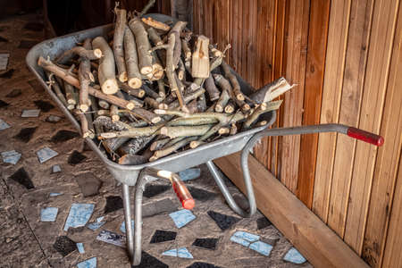 Finely chopped brushwood lies in a garden cart.の写真素材