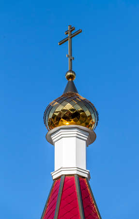 Golden cross on the dome of an Orthodox church close-up.の写真素材