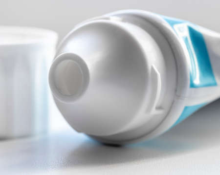 Partially used open tube with toothpaste close-up.の写真素材